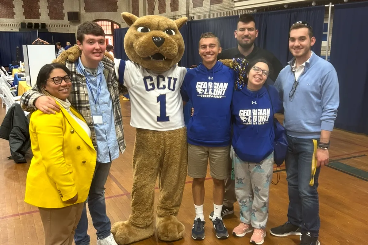 TCS students standing with Roary the lion