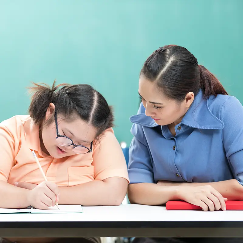 A teacher working with a student