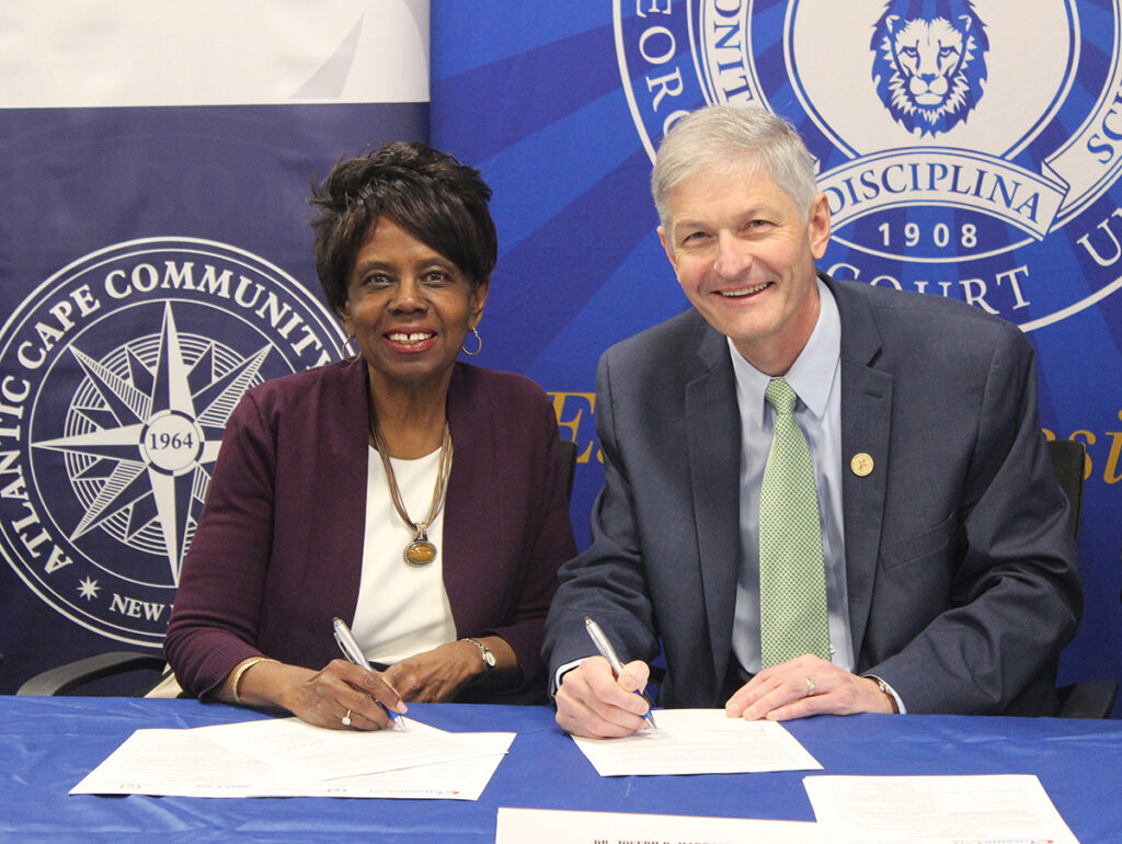 A woman and the president of GCU smiling