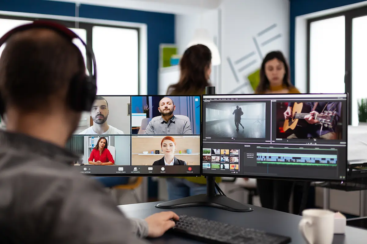 A male B.A. in Communication major editing a video