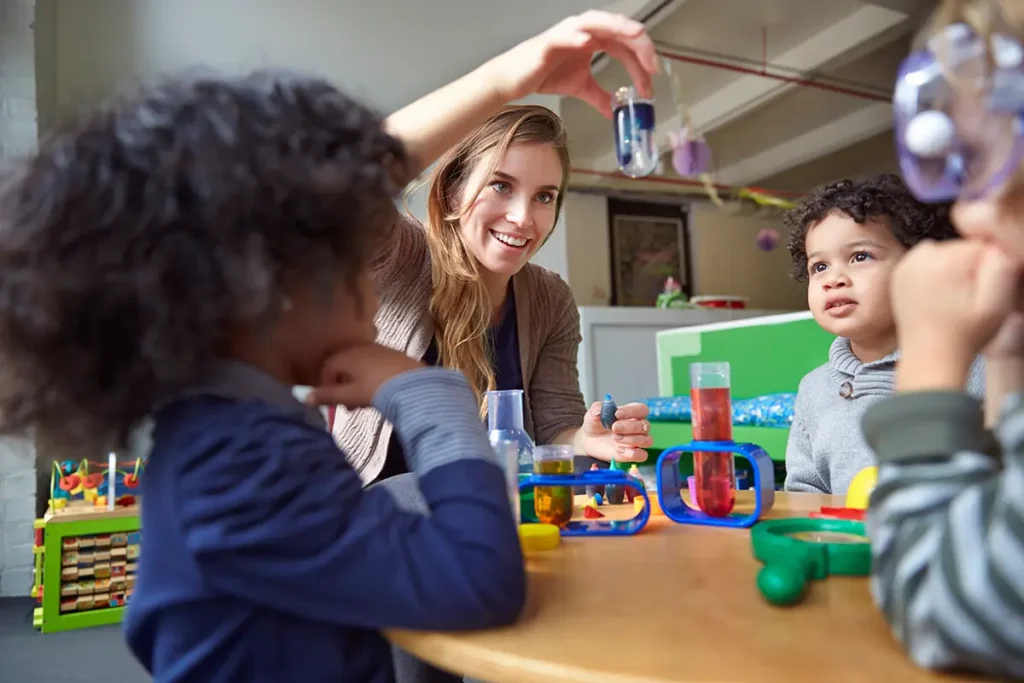 A Female Bachelor of Science in Natural Sciences teacher working with young students