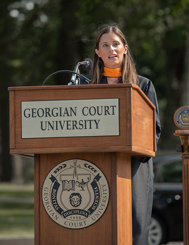 Brianna Marrone speaking at Convocation