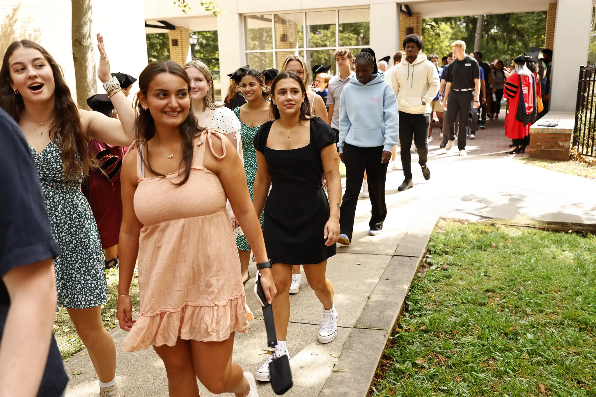 GCU Students walking on a path at Convocation 2024