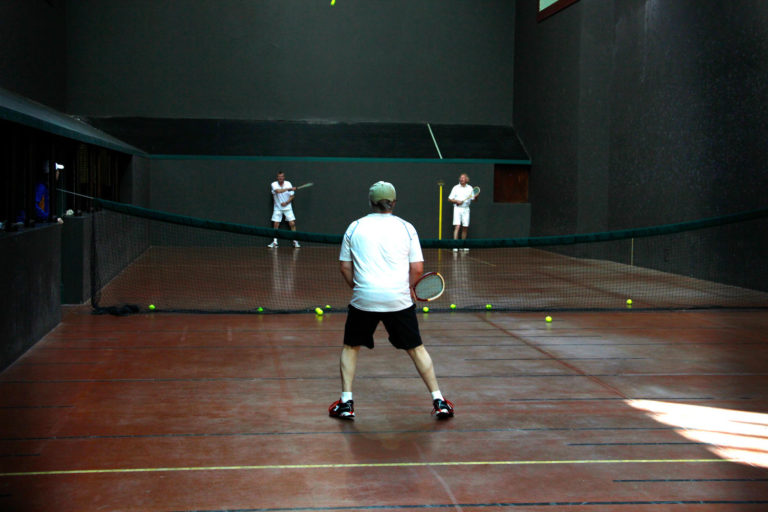 Man playing tennis at GCU.