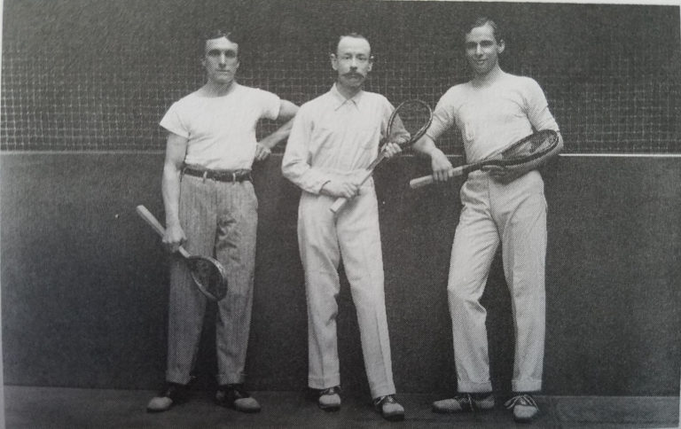 Old-fashioned group photo of men holding tennis rackets at GCU.