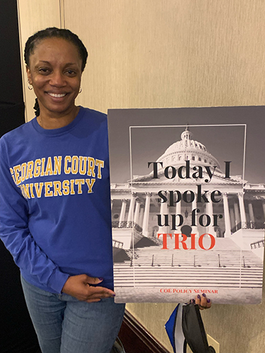 Danielle Lamb, director of GCU's TRIO program, with poster that says "Today I spoke up for TRIO"
