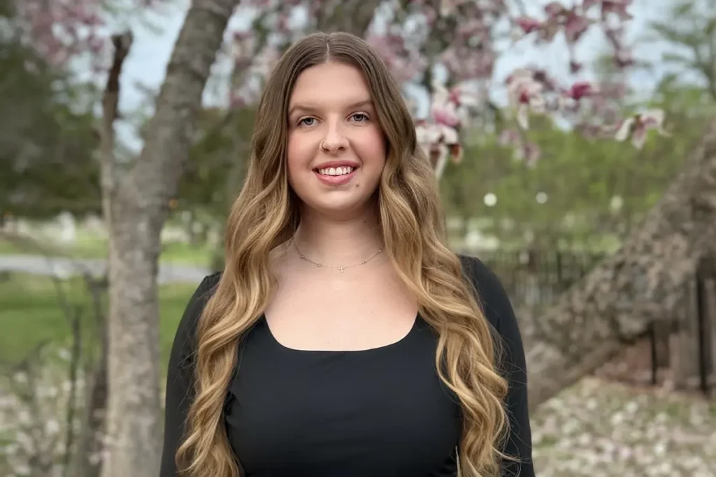 GCU graduate Emma Gildea posing for a picture outside