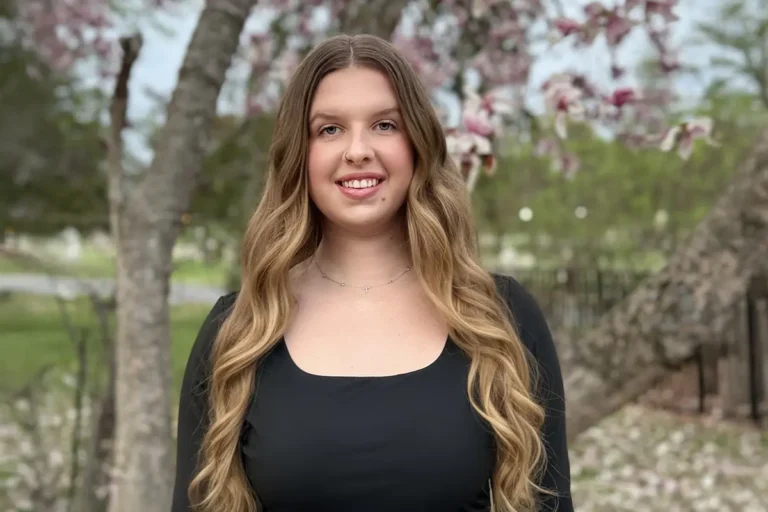 GCU graduate Emma Gildea posing for a picture outside