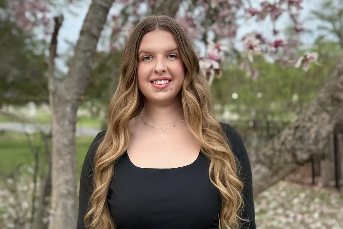 GCU graduate Emma Gildea posing for a picture outside
