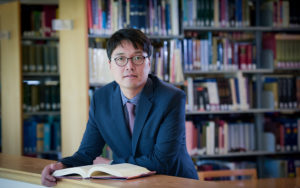 Man reading a book in the library