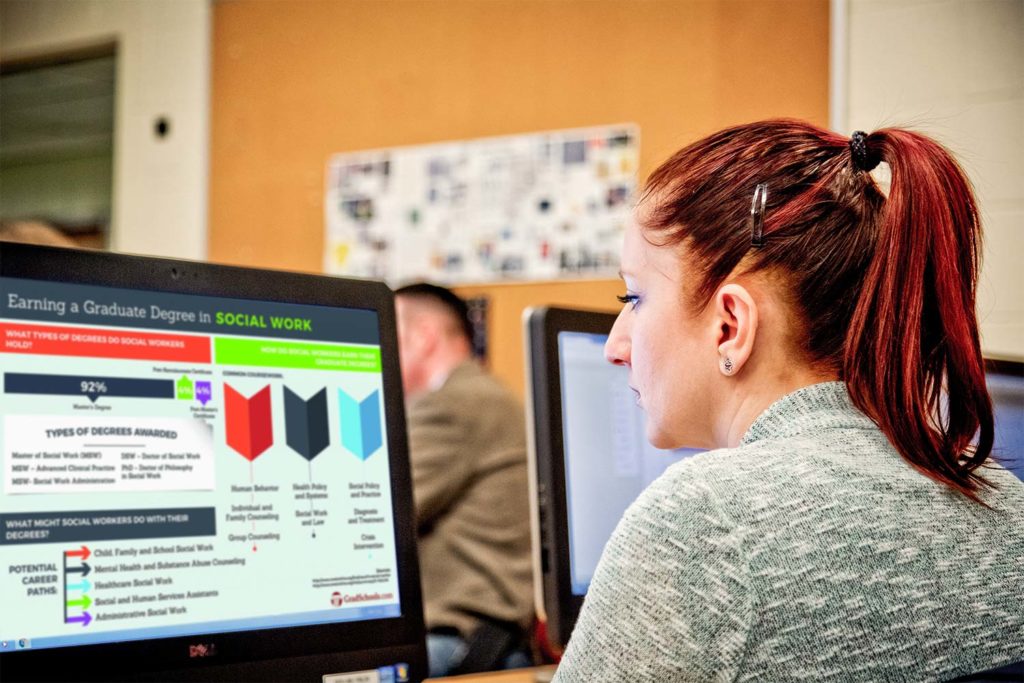 Woman using computer in class.