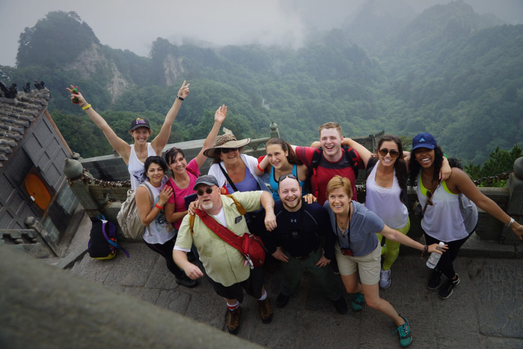 Students with arms wide open