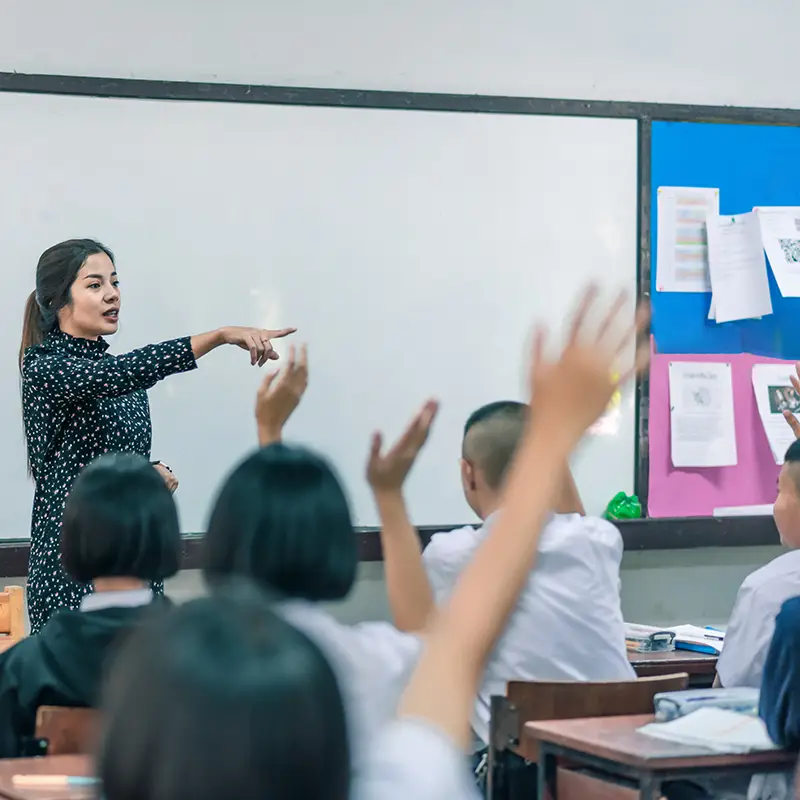 A woman teacher in front of a class