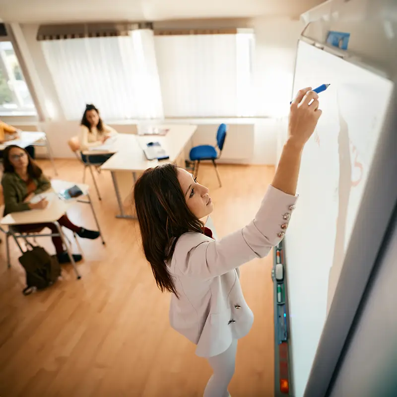 A woman teacher in front of a class