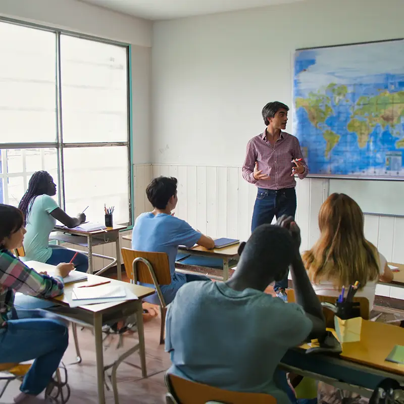 A male teacher in front of a class