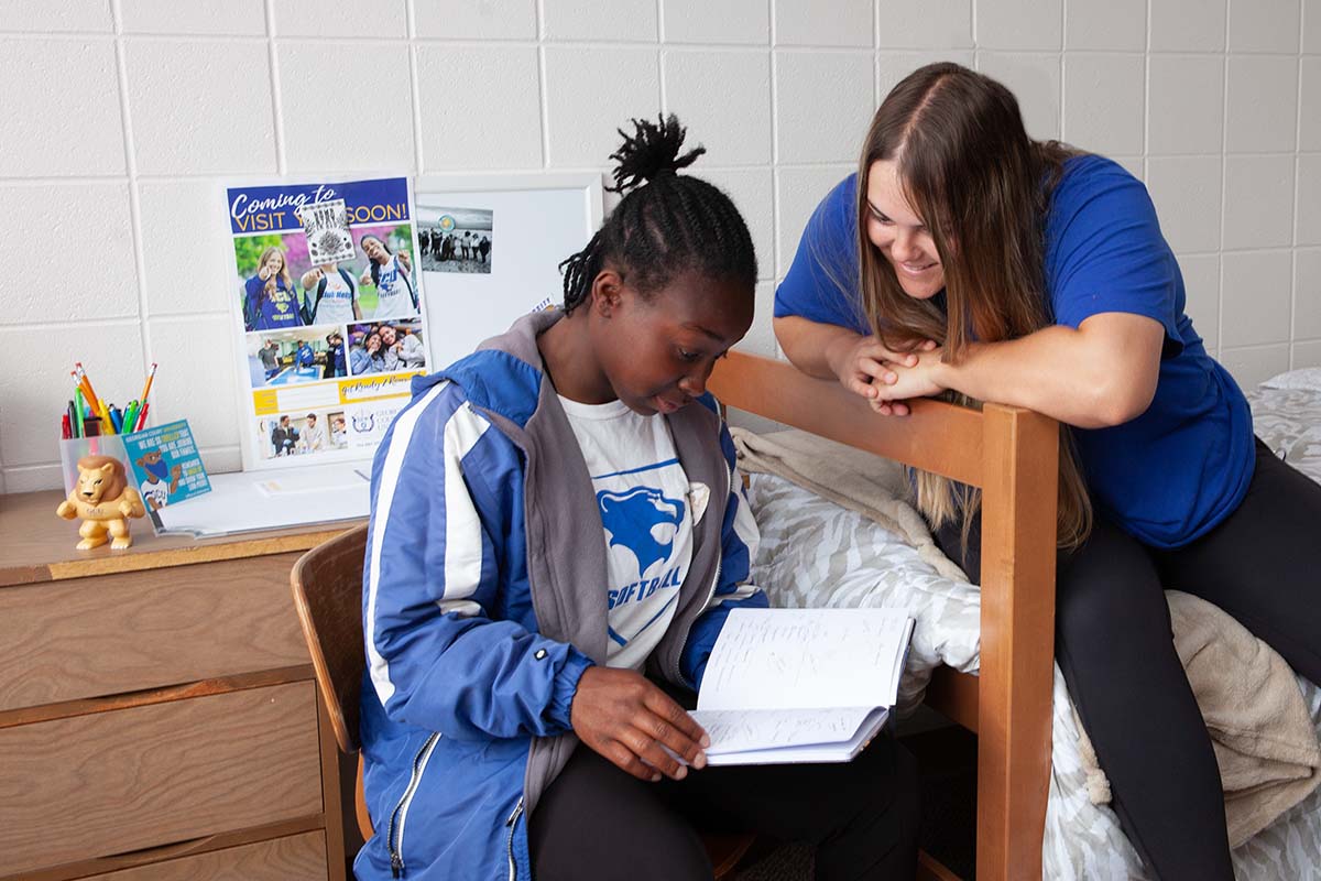 Two students studying in a dorm room