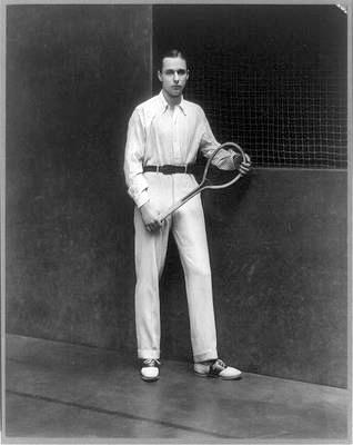 Old-fashioned photo of man holding tennis racket.