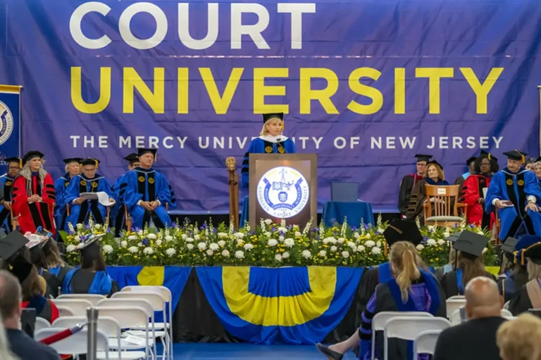 A woman speaking at a podium during commencement