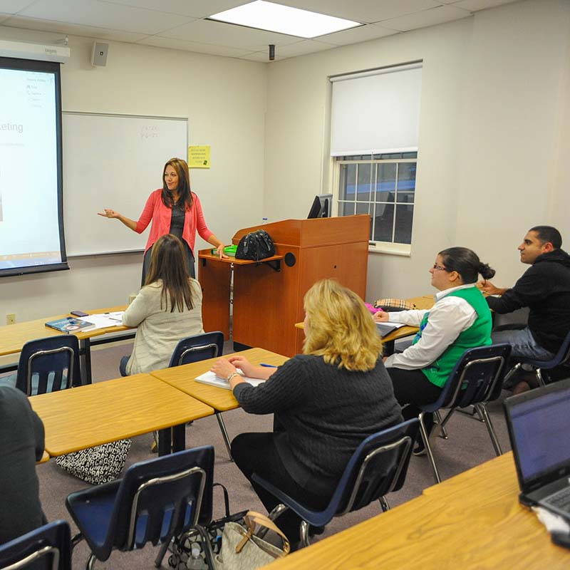 Dr. Ashley Elmore teaching a M.B.A. class