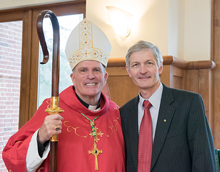 Priest and GCU president smiling