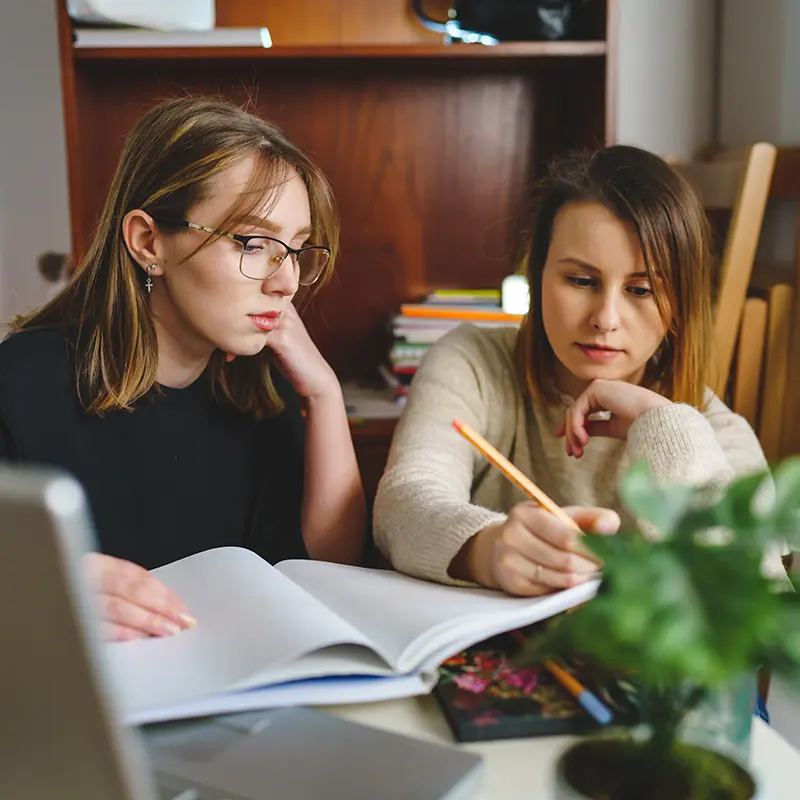 Two female Reading Specialist students doing work