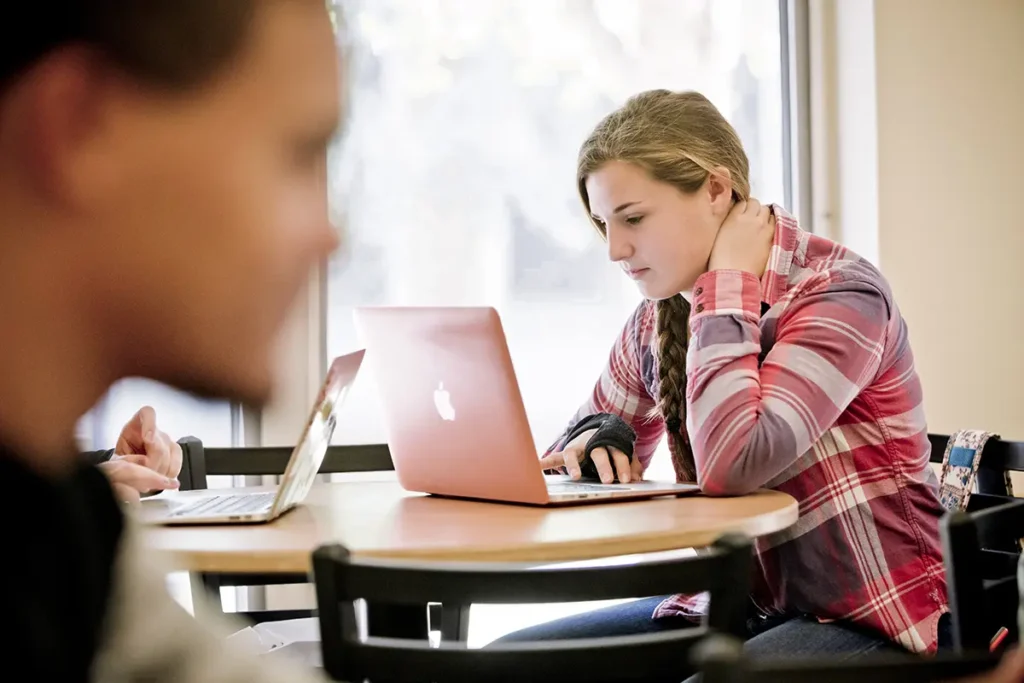 A female student working on a laptop computer