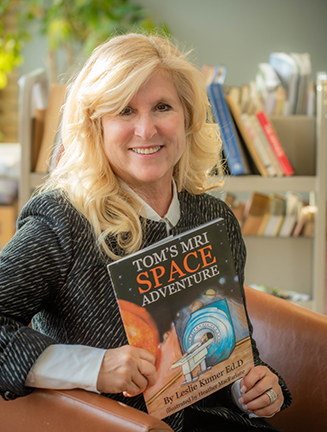 Author Leslie Kumer with book about MRI fear