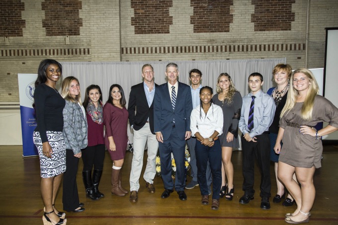 Student-athletes and Laura Liesman, director of athletics and recreation, with Dr. Marbach