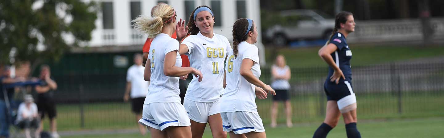 Women soccer players running in the field