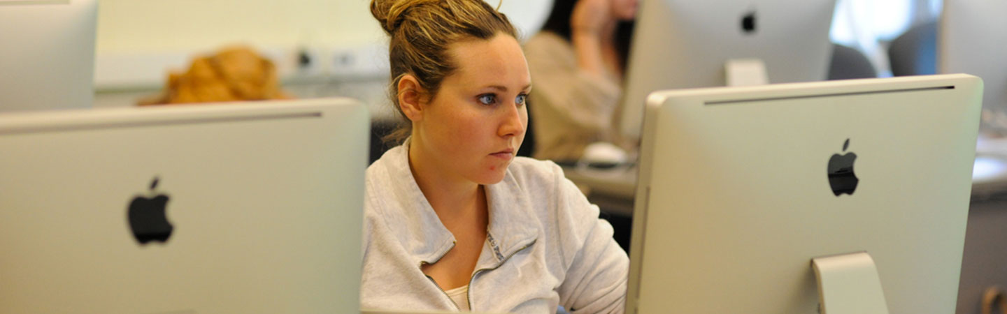 female on a computer in a classroom