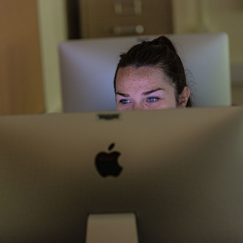 GCU Student working a MAC computer