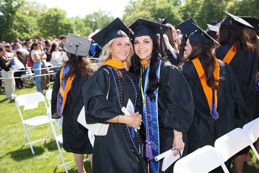 Two women in cap and gowns at GCU commencement