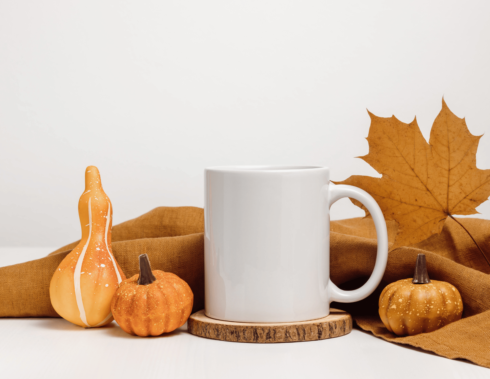 mug with fall decorations around it