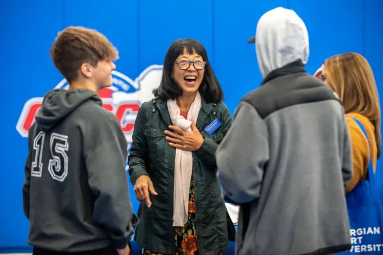 A GCU teacher talking with students