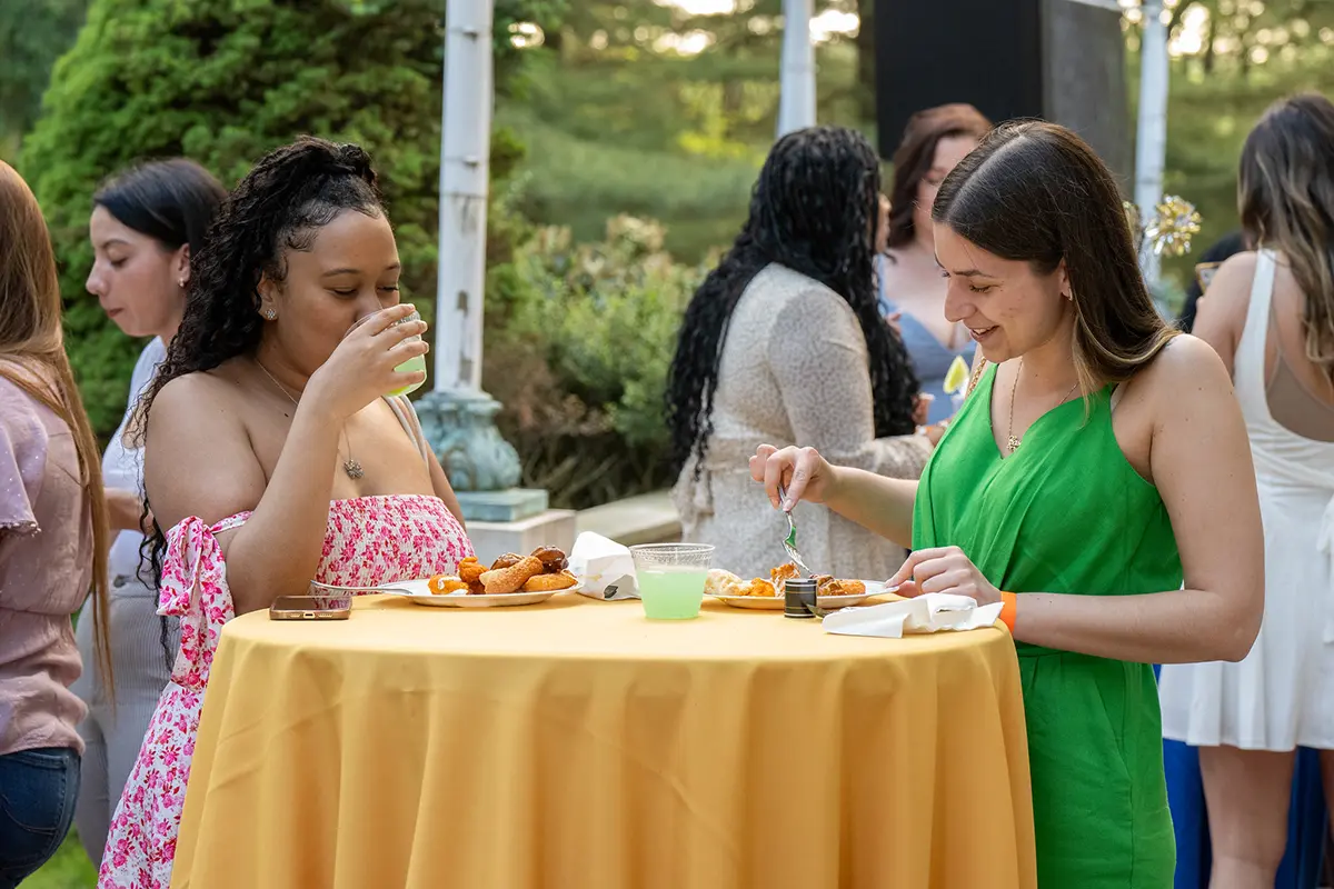 girls eating outside at the picnic on the patio event
