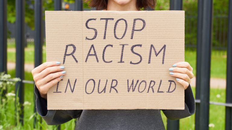 diversity woman holding sign stop racism