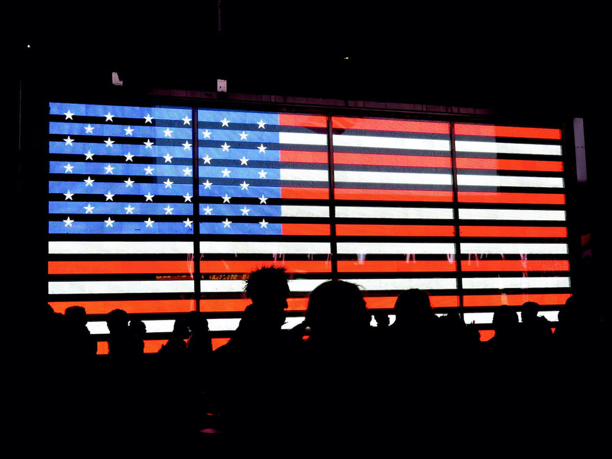 stars and stripes background with people in shadows